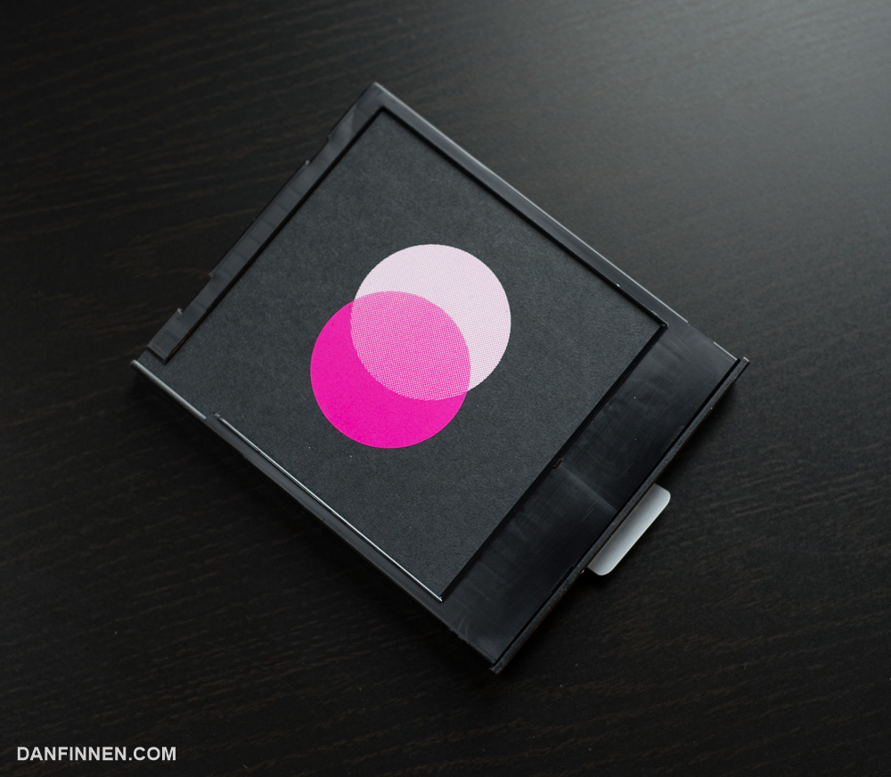 The 'darkslide' is a dark piece of cardboard that sits on top of the film cartridge when new. It protects the film underneath from light and is ejected by the camera when the cartridge is first put in.